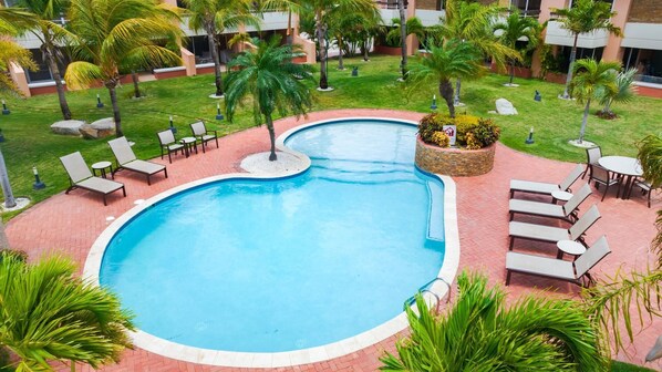 Step outside to your private oasis featuring a pristine pool, perfect for a refreshing dip or leisurely sunbathing. The sparkling water invites you to unwind and relax, surrounded by comfortable lounge chairs and a serene atmosphere.