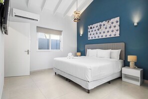 This bedroom is the perfect place for a restful night's sleep. It has a king bed, air conditioning, a television, and elegant headboard for your comfort.