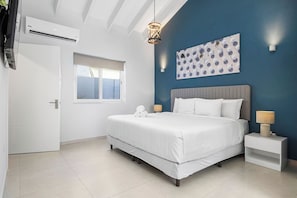 This bedroom is the perfect place for a restful night's sleep. It has a king bed, air conditioning, a television, and elegant headboard for your comfort.