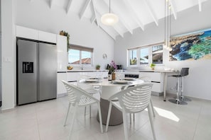 To accommodate your guests, the kitchen and dining area has a four-seater dining set and two bar stools.