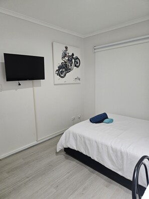 2nd bedroom with a TV double bed and a single bed on request