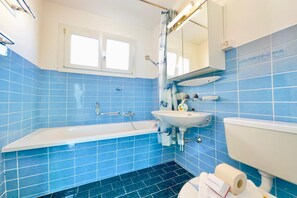 Bathroom with bath and shower