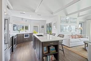 Upgraded and fully equipped kitchen with island seating and open to the living room.  Easy to cook and socialize with your group.