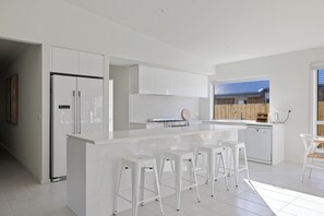 All-white and all smiles in this delightful kitchen.