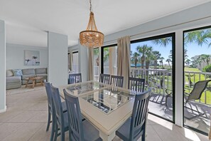 Dining area with access to private balcony and Gulf views