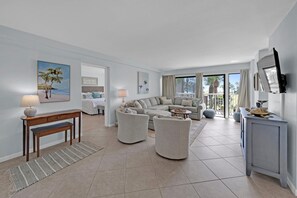 Living area with large private balcony and Gulf views. Workspace with seating.