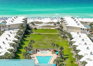 Aerial view of the pool, courtyard, beach and Gulf.