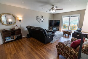 Enjoy the view and the electric fireplace while relaxing in one of 4 recliners