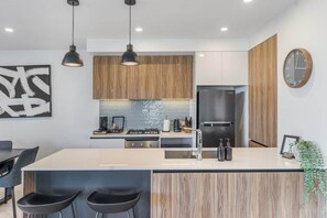 Kitchen with modern appliances and breakfast bar.