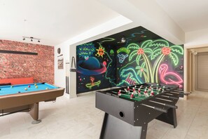 Discover the 85m2 playroom with pool, arcade, disco, card table & more.