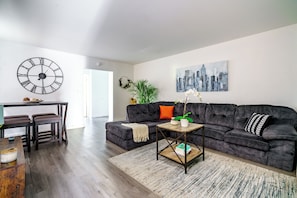 Downtown Columbus Airbnb; Refined Comfort in a Bright Space Unwind in our elegant living room, filled with bright, natural light and plush seating. The clean and spacious area offers the perfect environment for relaxation. Immerse yourself in the refined and inviting atmosphere