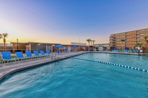 Experience a blissful coastal getaway at the heated pool with relaxing loungers
