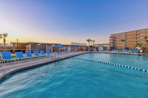 Experience a blissful coastal getaway at the heated pool with relaxing loungers