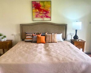 King size bed in an air-conditioned bedroom.