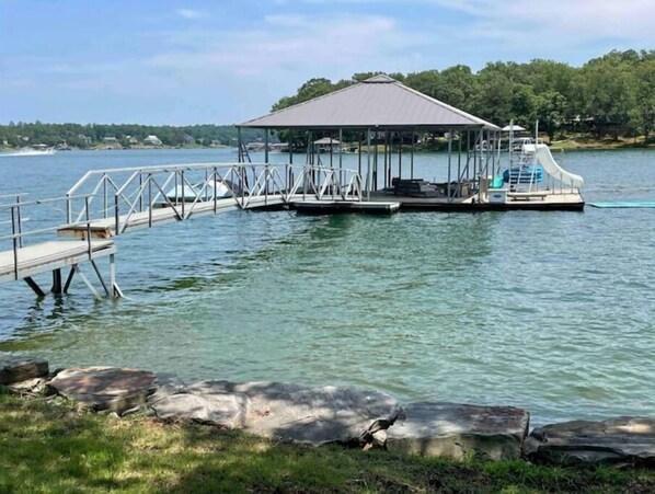 Covered concrete boat dock with slide