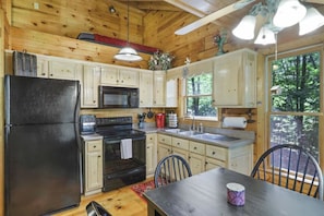 Loft above kitchen cabinets has smaller bed.
