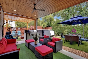 The backyard paradise boasted w/Swim spa/hot tub, outdoor grill & dining setup.