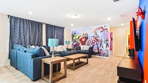 This superhero-themed living room boasts a comfy couch