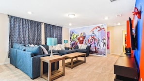 This superhero-themed living room boasts a comfy couch
