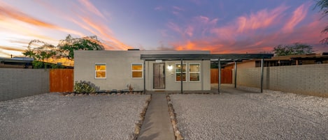 Front view of this newly remodeled home with 1-car carport and new lawn gravel