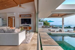 "Seamlessly transition from the open living area directly into the pool for a refreshing dip."