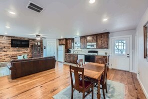 Open-concept living room with seamless flow to the kitchen and dining areas