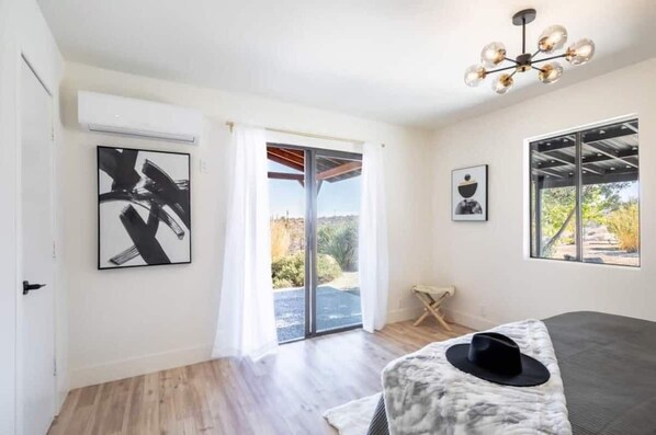 Master bedroom featuring king size bed and sliding doors to Sunrise Patio.