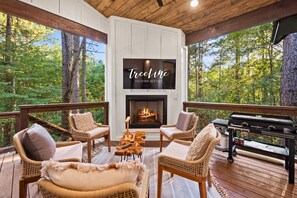 An outdoor lounge area featuring stylish seating and a white fireplace