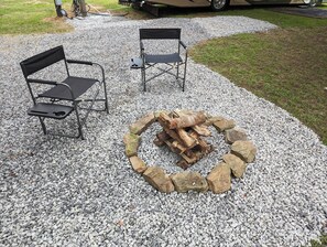 Sit around  and enjoy the calmness of a campfire with provided pit and wood.