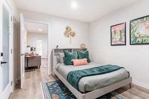 Primary bedroom with a queen sized bed and plenty of closet storage