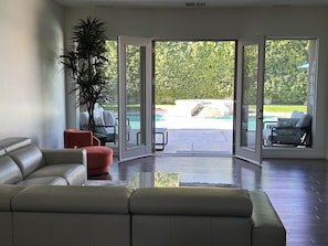 Relax in the spacious living room overlooking the backyard and pool