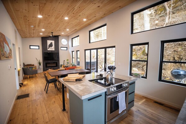 Glass wall opens onto the patio—bring the forest inside.