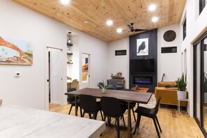 Modern dining setup with nature views and ambient lighting.