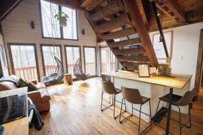 Spacious living room with vaulted ceilings and forest views—perfect for relaxing in Red River Gorge.