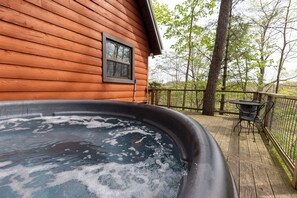 Unwind in your own bubbling hot tub surrounded by trees.