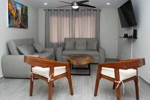 SPACIOUS LIVING ROOM - NEW FURNITURE, NEW 65 INCH HD/SMART TV, AND NEW A/C UNIT.