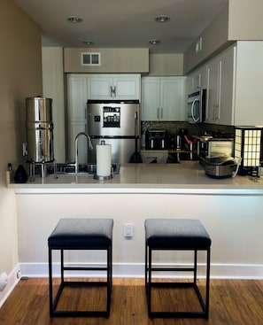 Kitchen with breakfast bar, Berkey water filter, and cooking accessories
