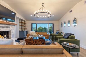 Living room with large windows, mini bar, and seating for all!