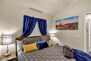 Experience a restful haven in a bedroom equipped with blackout curtains.