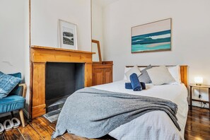 On the entry-level, the second bedroom offers a double bed and display fireplace.