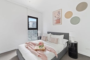 The 2nd bedroom with a double sized bed and plush pillows.