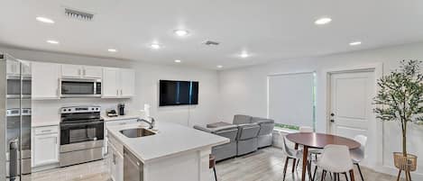 Living room with comfortable couch & big flat screen smart TV