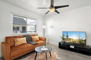 Relax in style on our burnt orange couch with prime viewing!