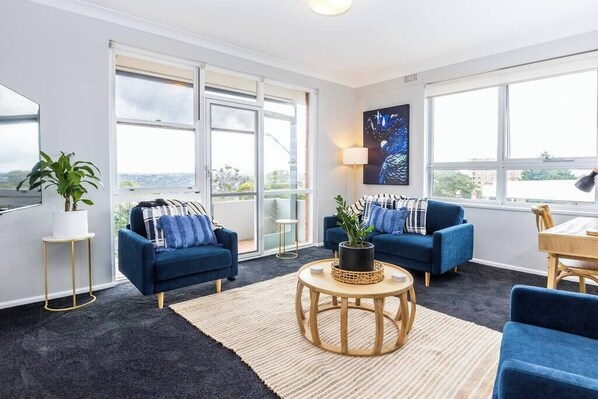 Living area flows onto balcony are and amazing views out to Middle Harbour