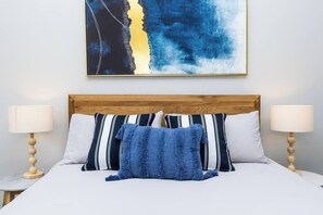 Sumptuous linen and new Queen bed with comfy mattress and pillows in an oversized master bedroom.