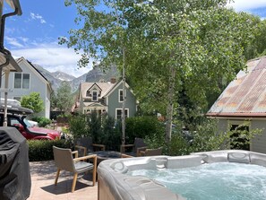 Private back patio at The Residence on South Oak with hot tub, grill and firepit