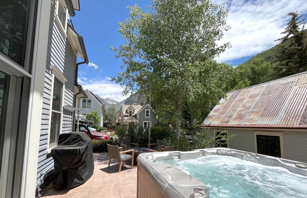 Private back patio with hot tub, grill and firepit