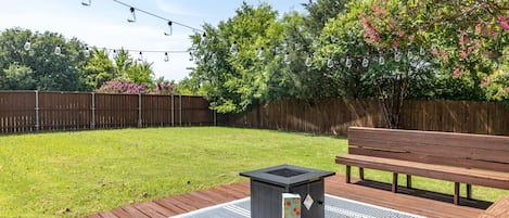 Large backyard with seating and fire pit