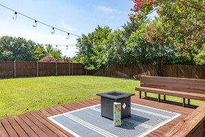 Large backyard with seating and fire pit