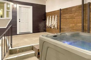 You will love hanging out in the enclosed back patio with a private hot tub and firepit